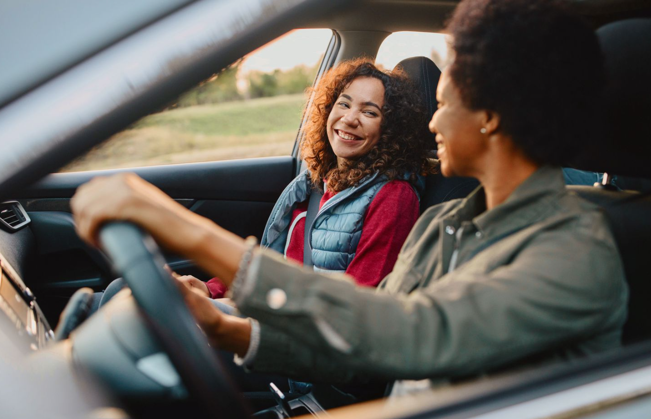 Red car driving through Worthington, Ohio, showcasing reliable car insurance coverage options from Insurance Company Worthington Ohio LLC
