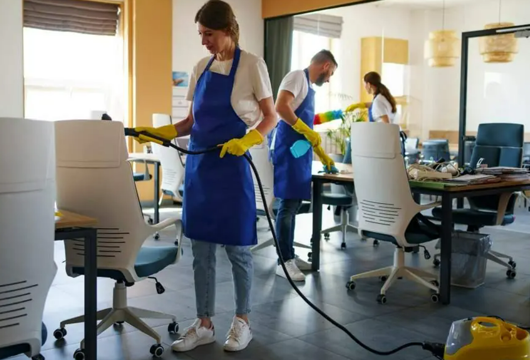 a professional cleaning crew wearing uniforms and using equipment, representing comprehensive cleaning service insurance coverage by Insurance Company Worthington Ohio LLC.