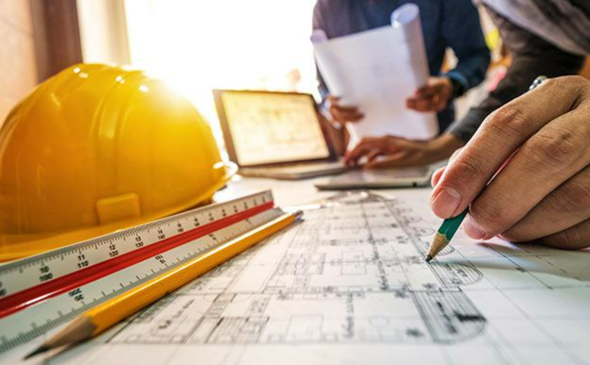 a contractor wearing a hard hat and safety vest at a construction site, representing comprehensive contractors insurance coverage in Columbus, Ohio, offered by Insurance Company Worthington LLC.