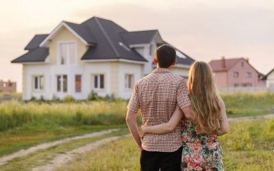 rear view of young couple looking at their new house